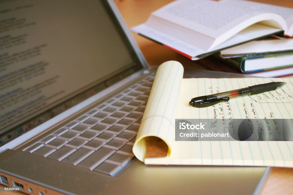 Laptop computer with books, pen and yellow legal pad Research Stock Photo Laptop computer with books, pen and yellow legal pad Research Stock Photo