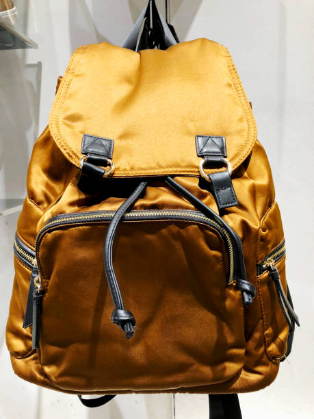 istock Gold female backpack with rhinestones on a white background. Selective focus 922594748