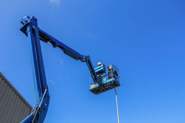 Electrical technician repairing street light by boom lift
