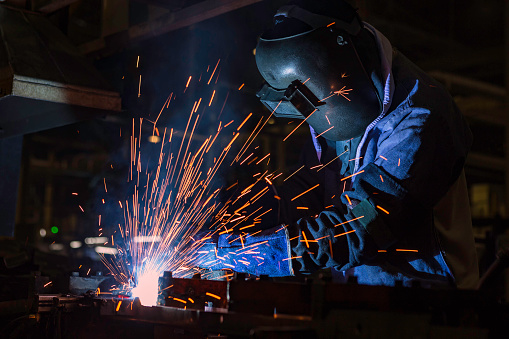 Industrial Worker at the factory welding closeup