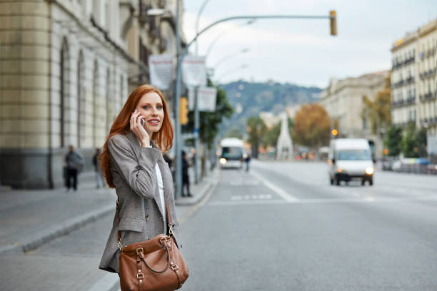 istock Young redhead commuter talking on smart phone 922595030