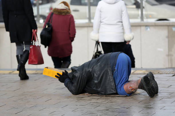 Homeless man begs for money Homeless man with hurt leg on his knees begs for money at the street. Ten years after joining the EU Bulgaria is still the poorest country in the union. walking for a cause stock pictures, royalty-free photos & images