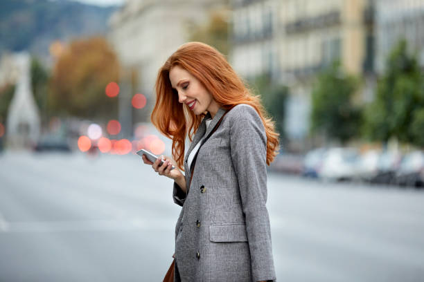 Happy Woman Smart Phone In City Stock Photo - Download Image Now - - Jacket, Women, One Woman Only - iStock