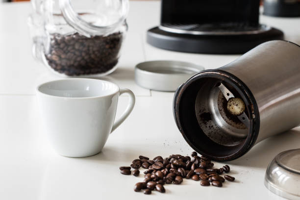 istock Morning coffee in the kitchen. Coffee grinder and coffee maker with coffee makers on a white kitchen table. Time of the day, morning. 922595088