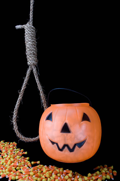 Halloween pumpkin with candy and noose stock photo