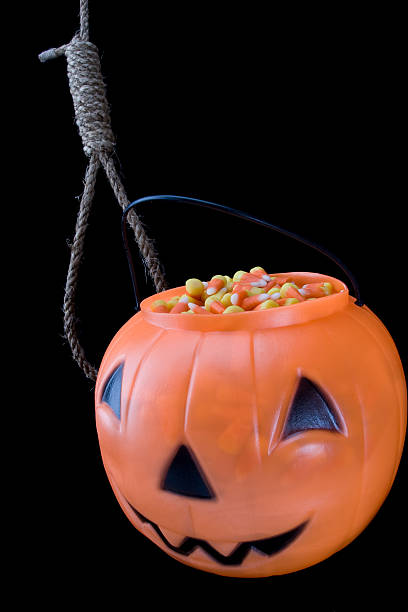 Halloween pumpkin jack o' lantern with noose on black background stock photo