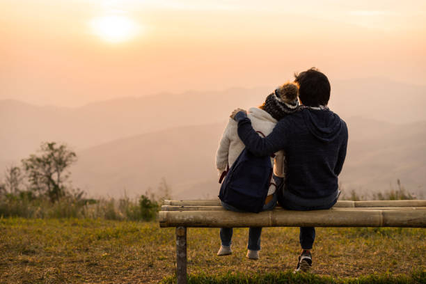 istock Loving couple embracing on the mountain at sunset. 922604426