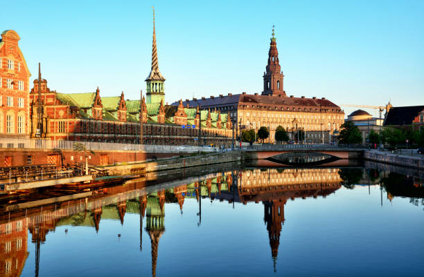 Borsen Building, Copenhagen Borsen Building (The Old Stock Exchange) & Christiansborg Palace at sunrise, Copenhagen, Denmark copenhagen stock pictures, royalty-free photos & images