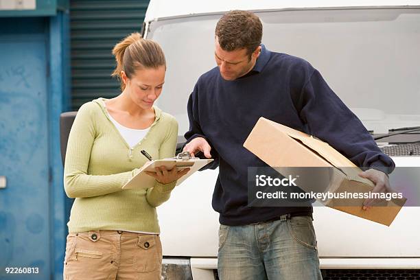 Man Delivering Parcel Stock Photo - Download Image Now - 20-29 Years, 30-39 Years, Adult