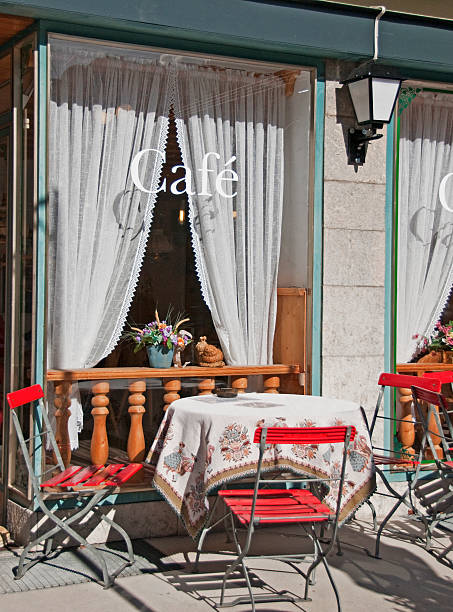 istock Sunny sidewalk cafe red chairs local tablecloth outdoors 92260858