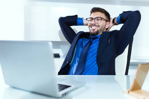 istock Handsome young businessman relaxing after working in the office. 922611496