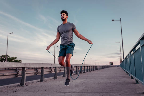 Perfecting his form Young man jumping rope outside skipping stock pictures, royalty-free photos & images