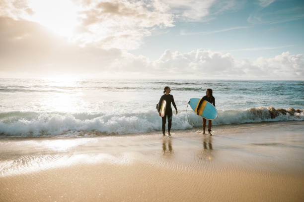 istock Sporty women going surfing 922619250