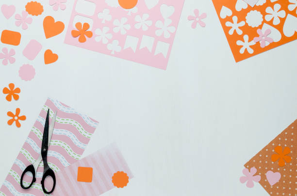 istock Bright colored shapes, pink sheets of paper and scissors on white background 922623652