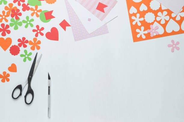 istock Multi-colored shapes cut from paper, scissors and a scalpel on a white background 922623664