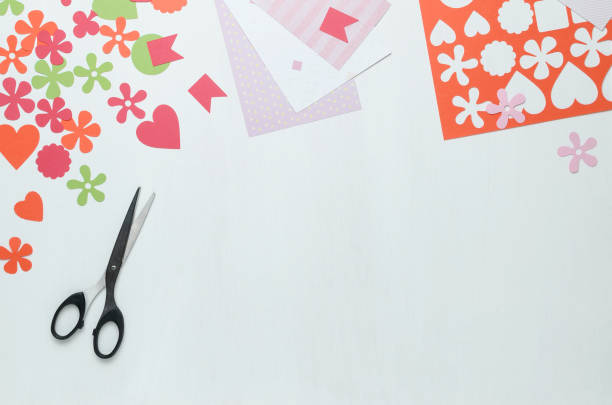 istock Multi-colored shapes cut from paper and scissors on a white background. The view from the top 922623860