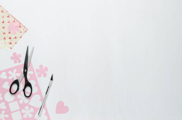 istock Scissors, scalpel, and figures cut from pink paper 922623878