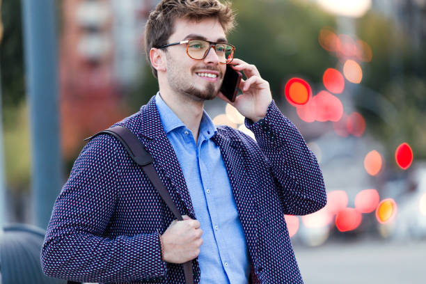 istock Handsome young businessman using his mobile phone in the street. 922624020