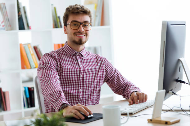istock Handsome young businessman using his laptop in the office. 922624110