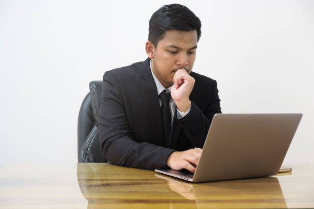 istock man serious working with laptop in office 922629506
