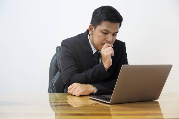 istock man serious working with laptop in office 922633124