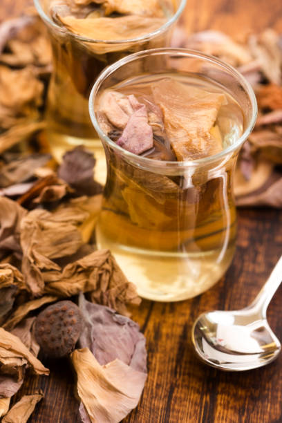 istock Lotus petals tea on wooden background 922633534