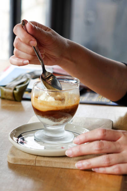 istock hand with spoon taking Affogato coffee with ice cream 922635152
