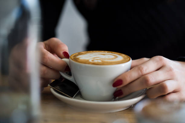 istock Women holding a cup of hot latte 922636346
