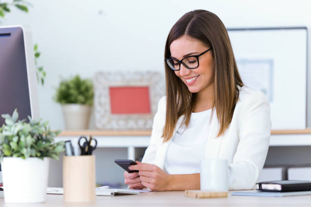 istock Business young woman using her mobile phone in the office. 922637332