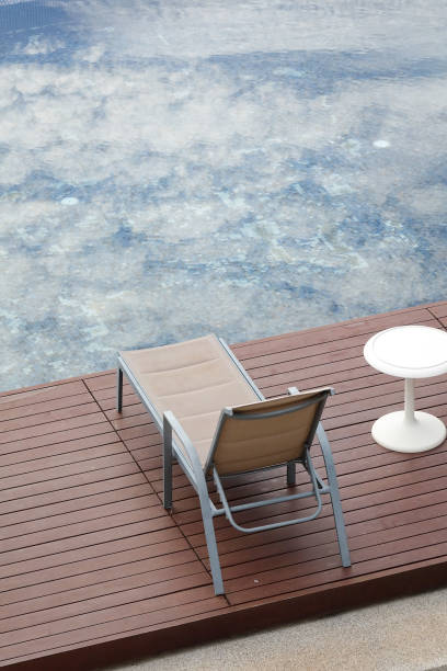 istock Chaise lounge around swimming pool 922640750