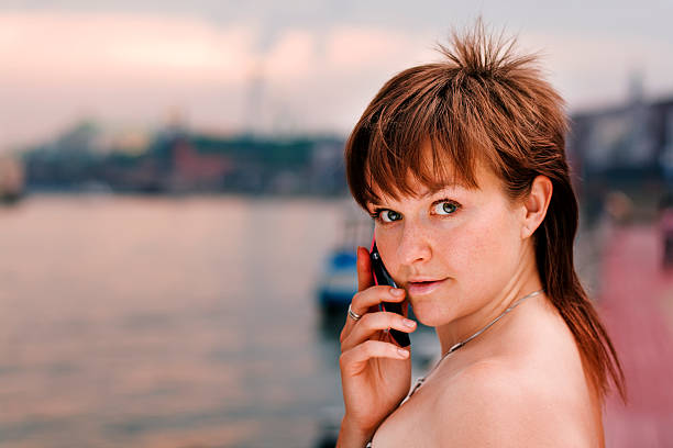 young woman speaking on the phone stock photo