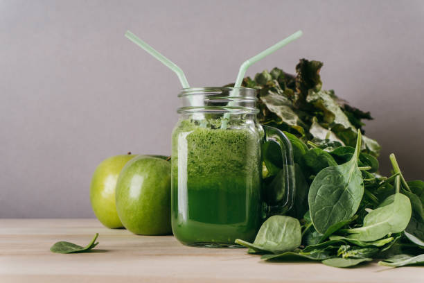 istock Green juice glass with two straws 922649564