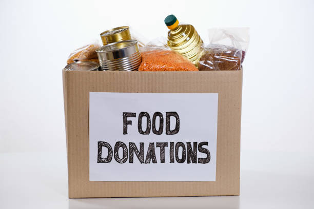 Food in a donation cardboard box, isolated on white background