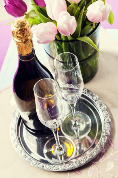 istock Two empty champagne flutes and a bottle of sparkling wine 922653644
