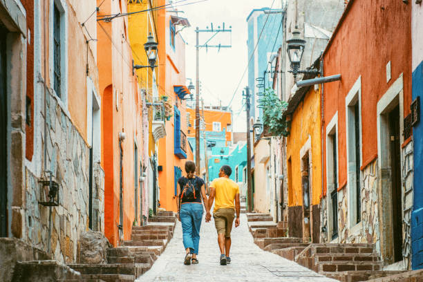 Couple walking the colorful narrow streets of Guanajuato in Mexico