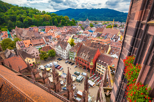 Aerial view of the historic city center of Freiburg im Breisgau from famous Freiburger Minster in beautiful evening light at sunset with blue sky and clouds in summer, Baden-Wurttemberg, Germany