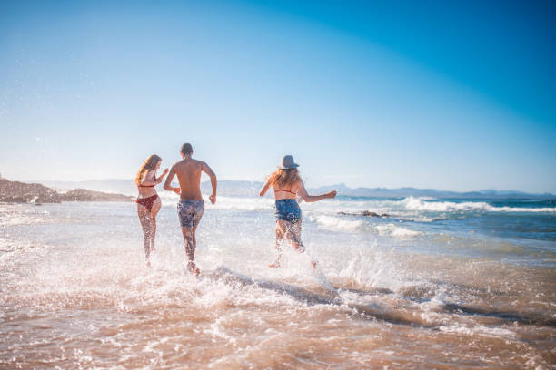 istock Friends running on the beach 922658006