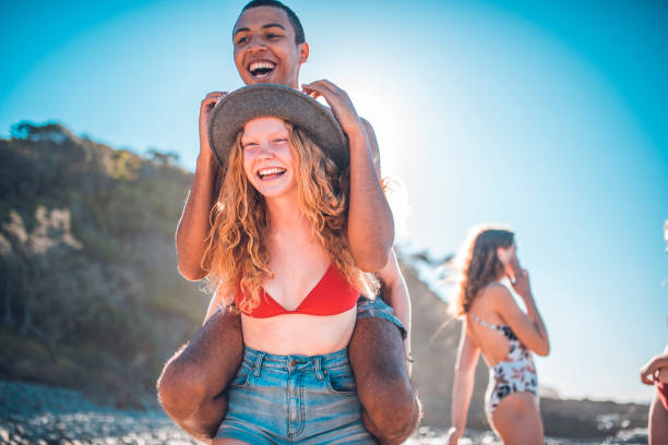 istock Girlfriend piggybacking her boyfriend on the beach 922658008