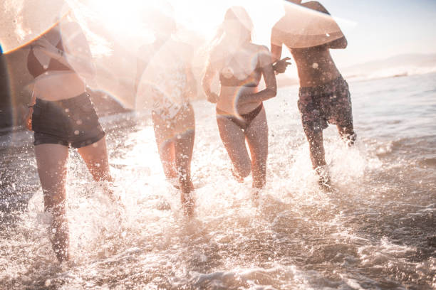 istock Friends running on the beach 922658070