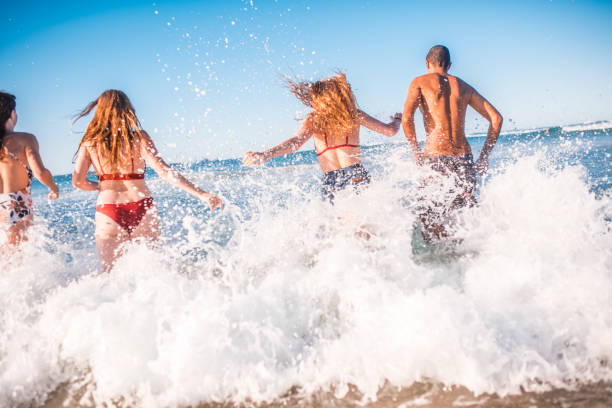 istock Friends running into the sea 922658072