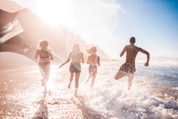 istock Friends running on the beach 922658074