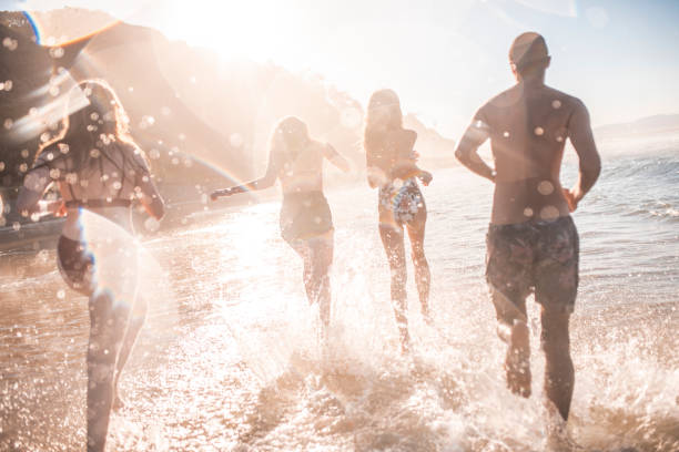 istock Friends running on the beach 922658076