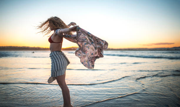 istock Young woman spinning on the beach 922658180
