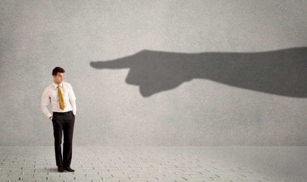 istock Business person looking at huge shadow hand pointing at him concept 922660024