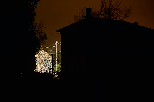 Spooky moon above the house at night