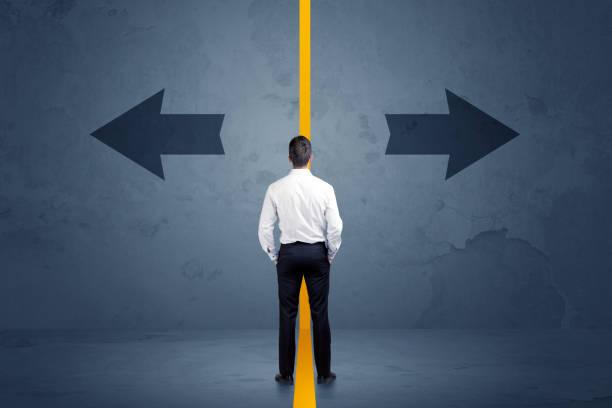 istock Business person choosing between two options separated by a yellow border arrow 922662048