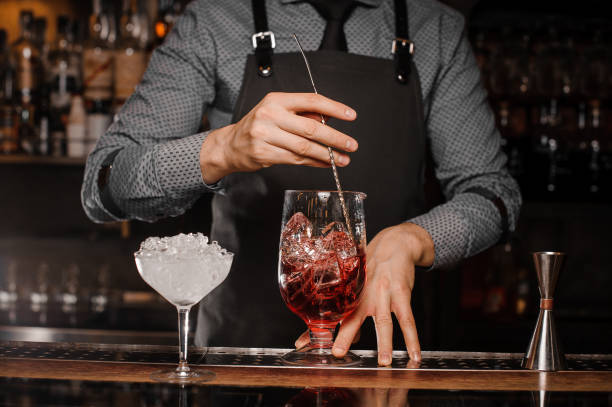 istock Barman stirring an alcoholic drink with ice in a cocktail glass 922662146