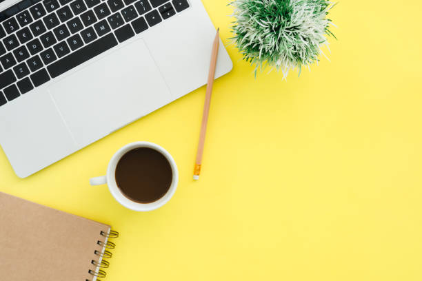 istock Minimal work space - Creative flat lay photo of workspace desk. Top view office desk with laptop, notebooks and coffee cup on pastel color background. Top view with copy space, flat lay photography. 922662540