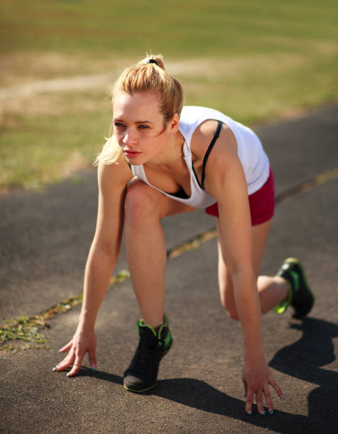 istock Young athletic girl preparing for run the race at start 922666634