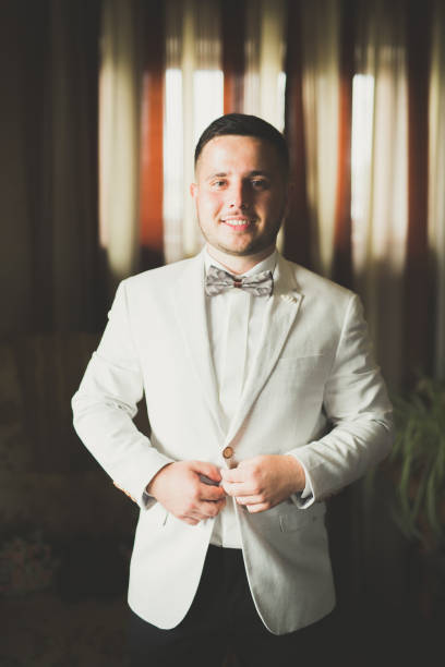 istock Grooms morning preparation. Handsome man getting dressed and preparing for the wedding 922666762